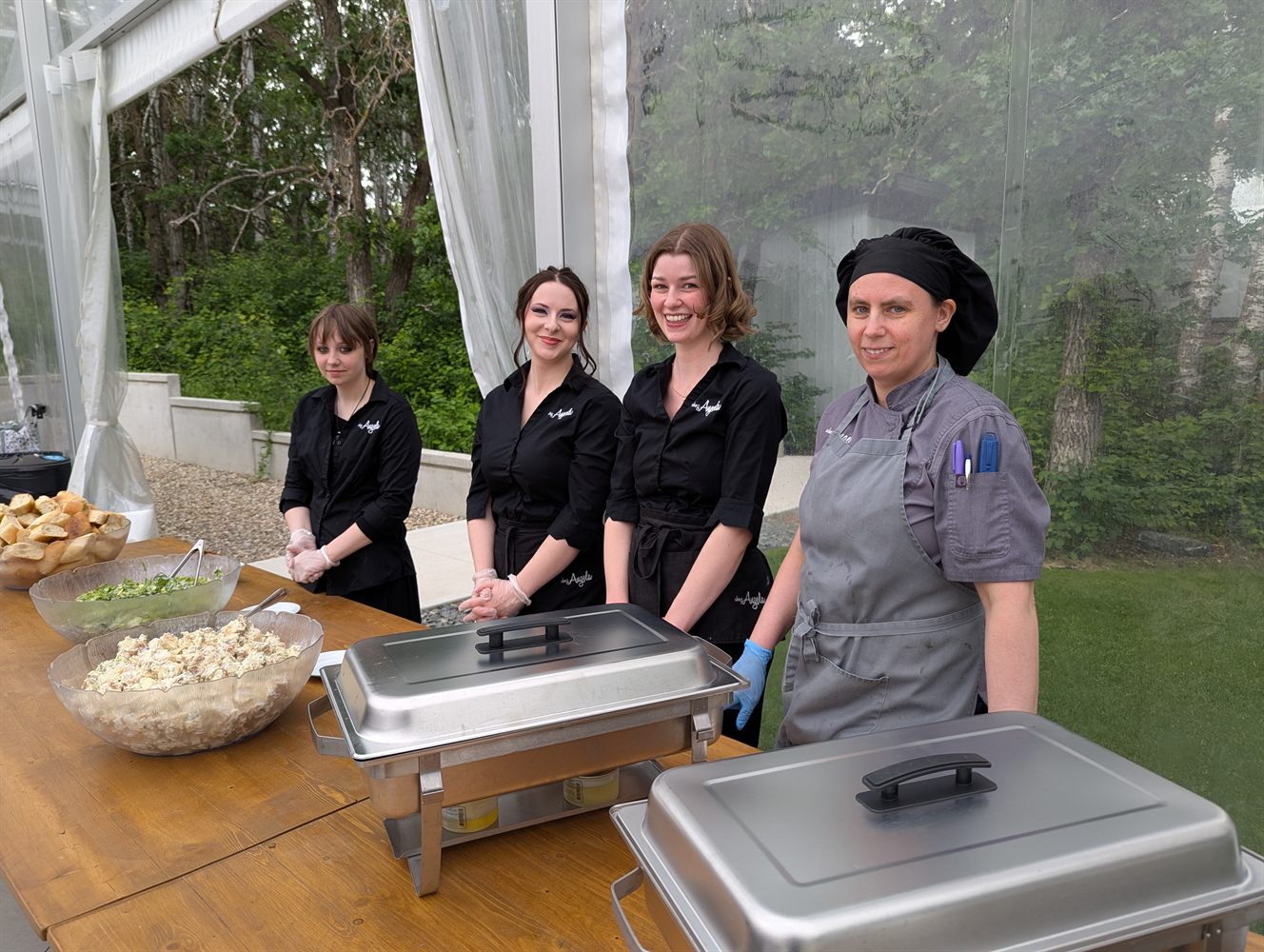 Chez Angela team serving at an outdoor event