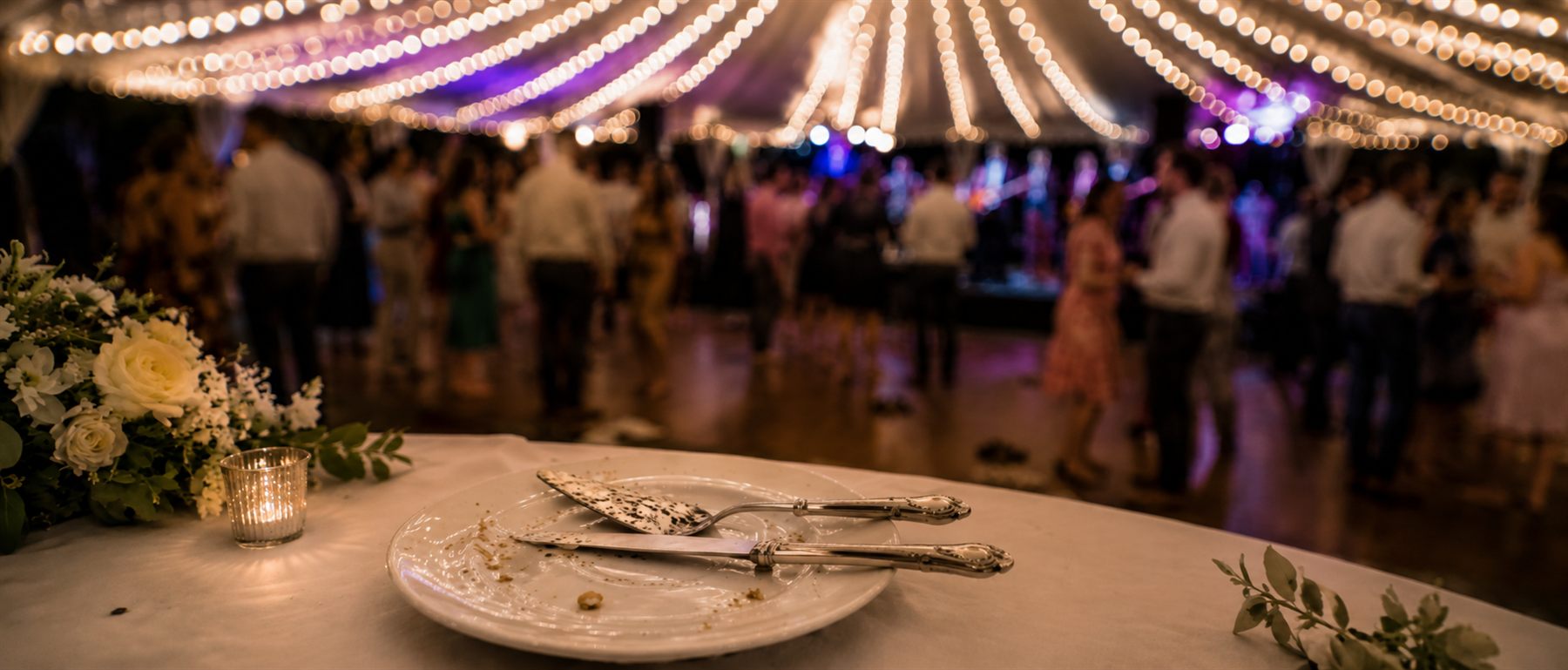 Outdoor wedding reception with warm lights